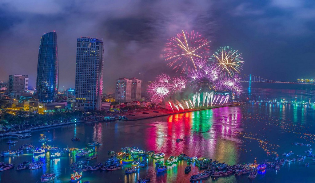 Fireworks explode off a floating stage on Han River bank